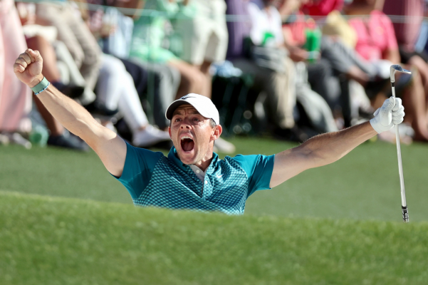 Rory McIlroy of Northern Ireland reacts after chipping in for birdie from the bunker on the 18th green during the final round of the Masters at Augusta National Golf Club on April 10, 2022 in Augusta, Georgia.