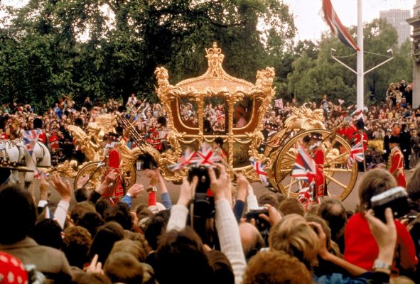 Crowds hail Queen Elizabeth II and her husband, Prince Philip, during the her Silver Jubilee procession on June 7, 1977. 