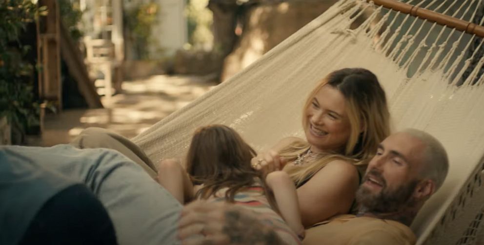 Adam Levine and wife Behati Prinsloo in a scene from Maroon 5's music video, "Middle Ground, " released May 23, 2023.