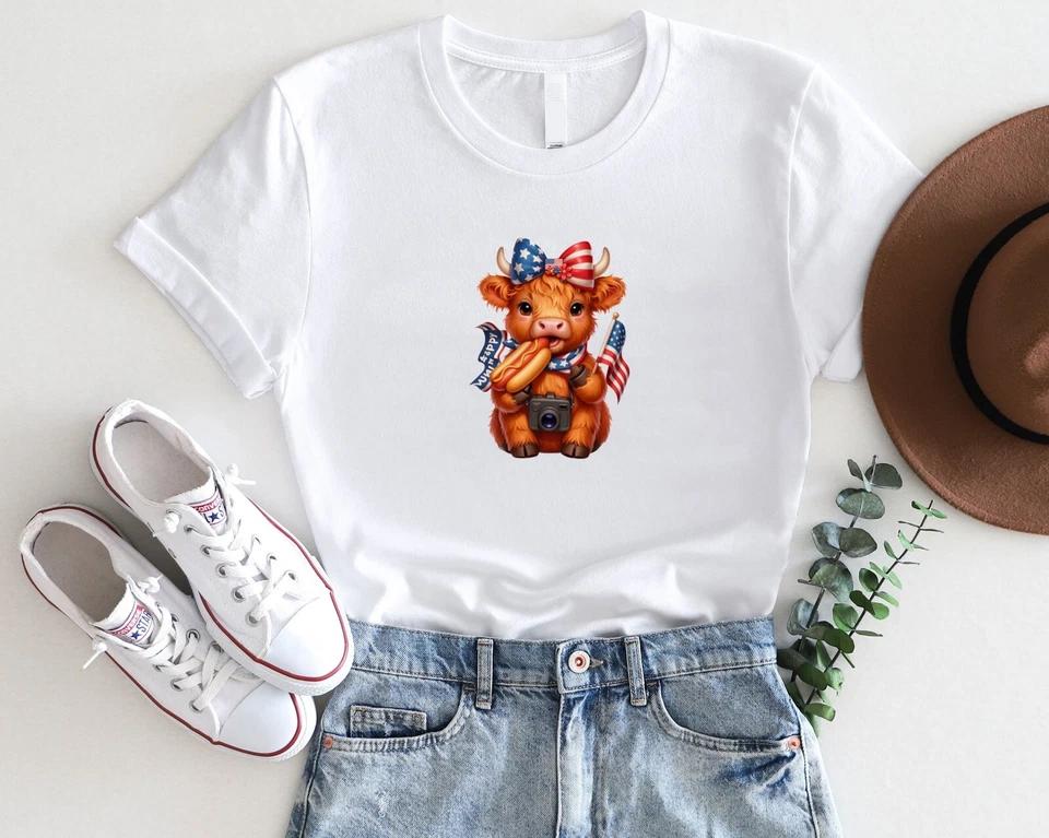 Patriotic Highland Cow T-Shirt – Cute 4th of July Cow with Hot Dog & Flag