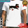 Top Dachshund running with a bouquet of red flowers in her mouth shirt